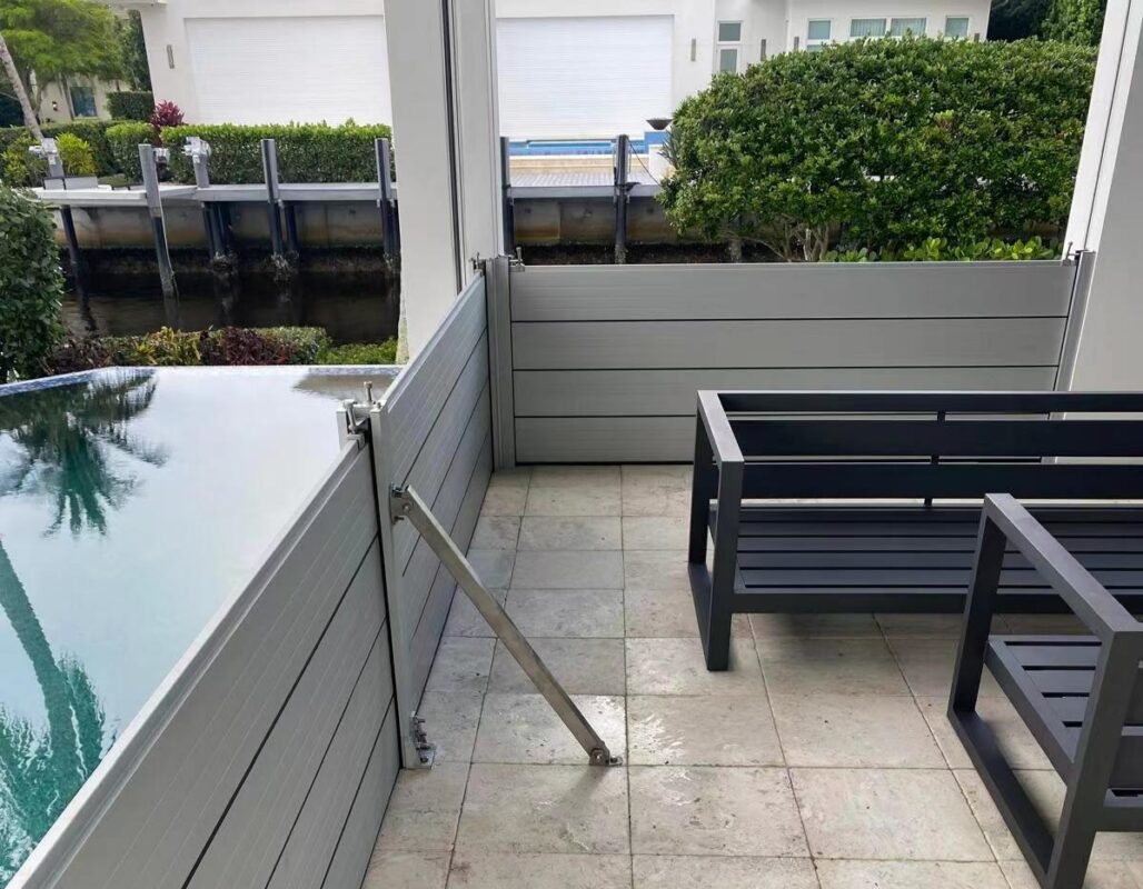 Removable aluminum flood barrier system installed around a covered residential patio and pool area
