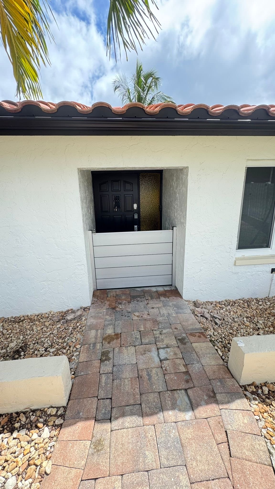 Custom aluminum flood barrier installed at a residential front door entrance in Bonita Springs, Florida
