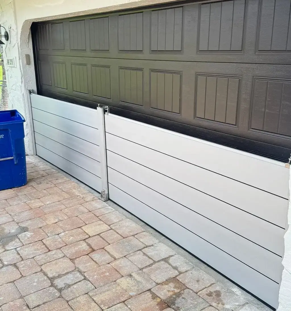 Residential aluminum flood barrier protecting a garage door opening