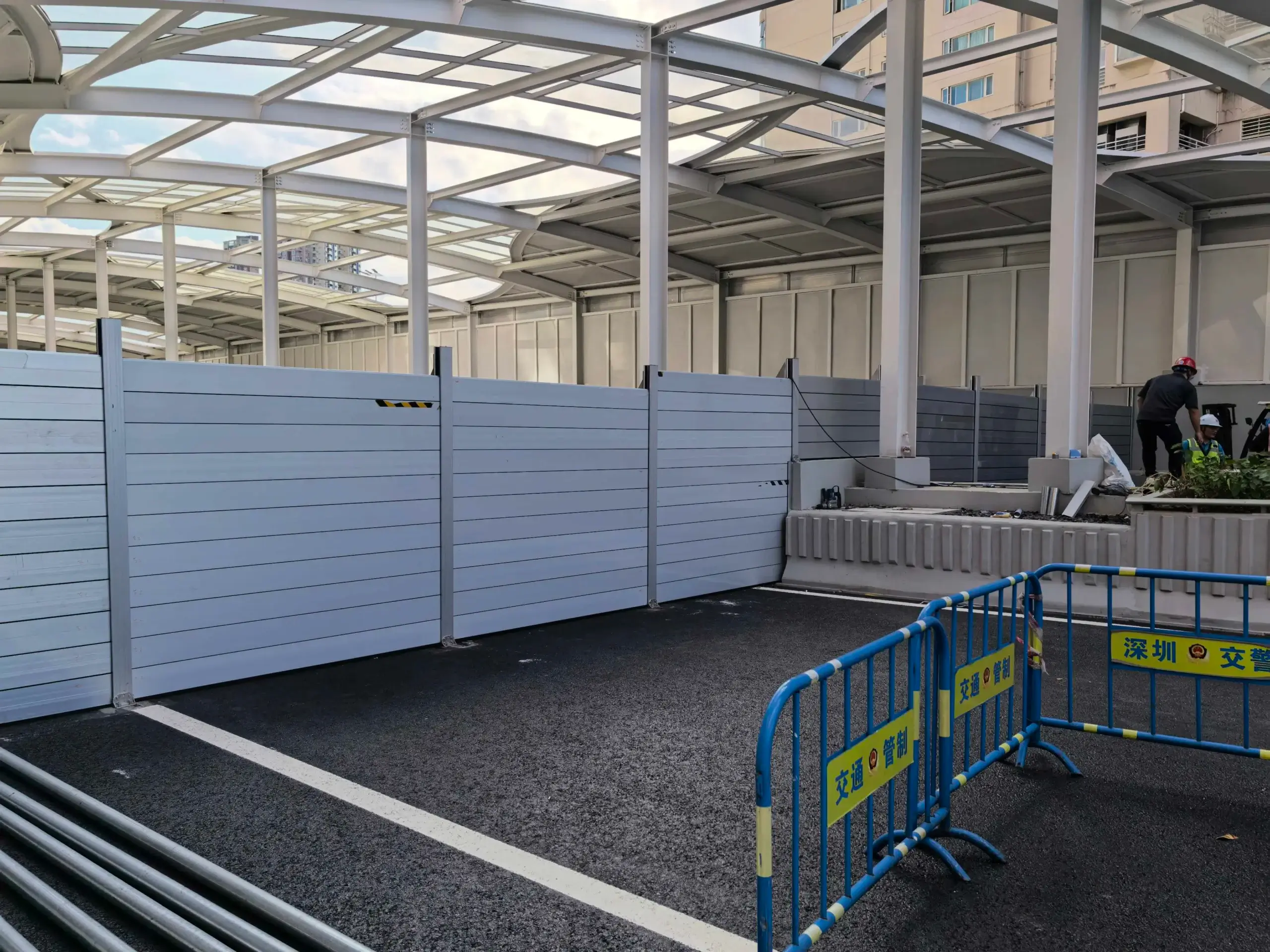 Installed aluminum flood barrier with 94.49-inch protection height beneath a steel canopy