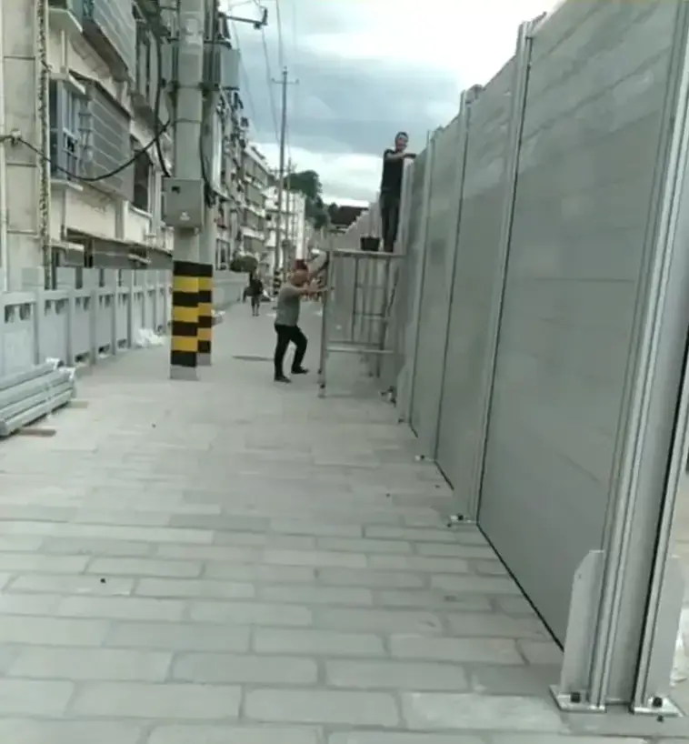Completed street-side aluminum flood barrier project with 157.48-inch protection height