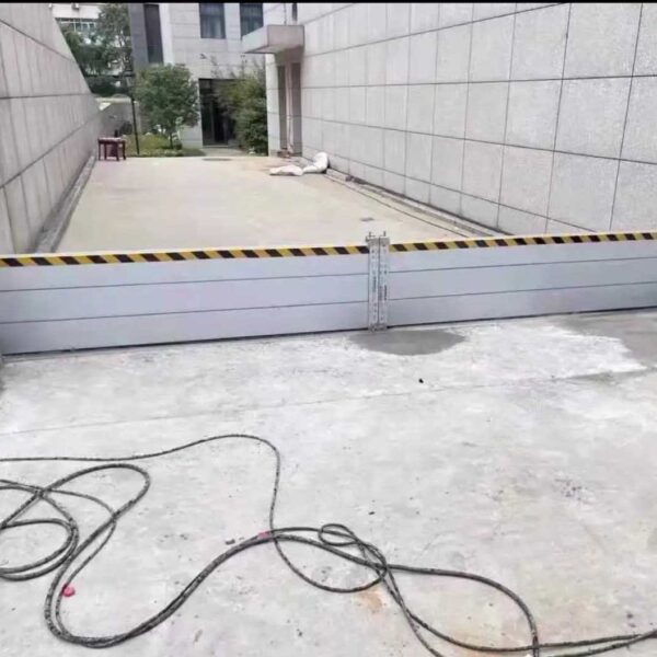 Aluminum flood barriers installed across a building access ramp in Naples Florida